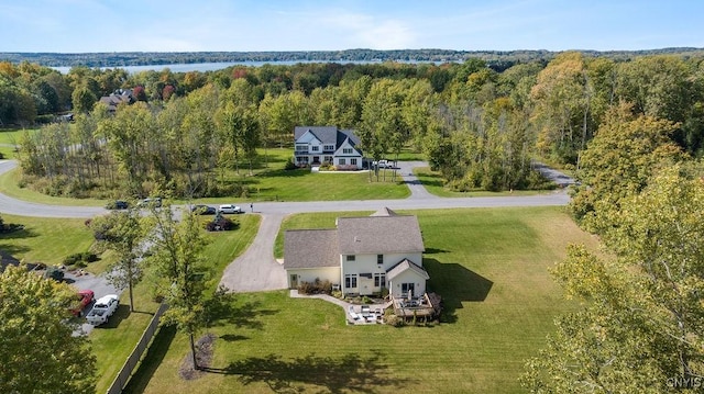 birds eye view of property featuring a view of trees