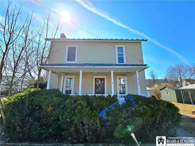 216 S Pleasant St, Shinglehouse, PA 16748 - view of front of home featuring a porch and a chimney