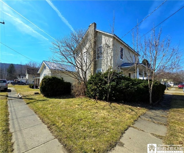 216 S Pleasant St, Shinglehouse, PA 16748 - view of property exterior featuring a yard and a chimney