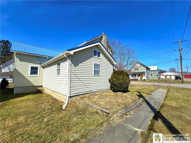 216 S Pleasant St, Shinglehouse, PA 16748 - view of side of home with metal roof and a lawn