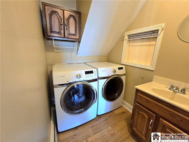 216 S Pleasant St, Shinglehouse, PA 16748 - laundry room with light wood finished floors, independent washer and dryer, a sink, and cabinet space