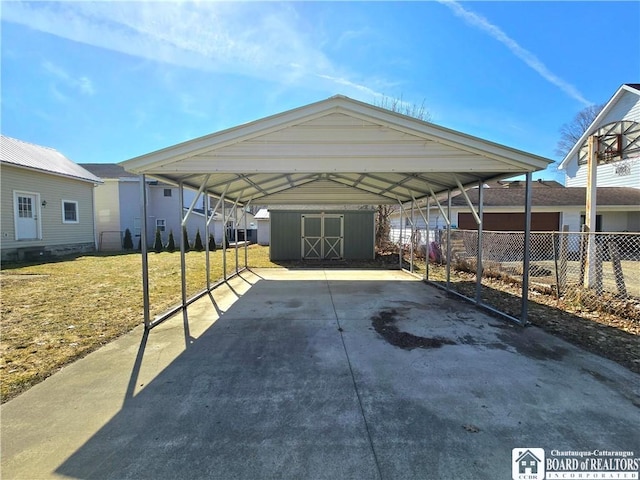 216 S Pleasant St, Shinglehouse, PA 16748 - exterior space with a carport, concrete driveway, fence, and a storage unit