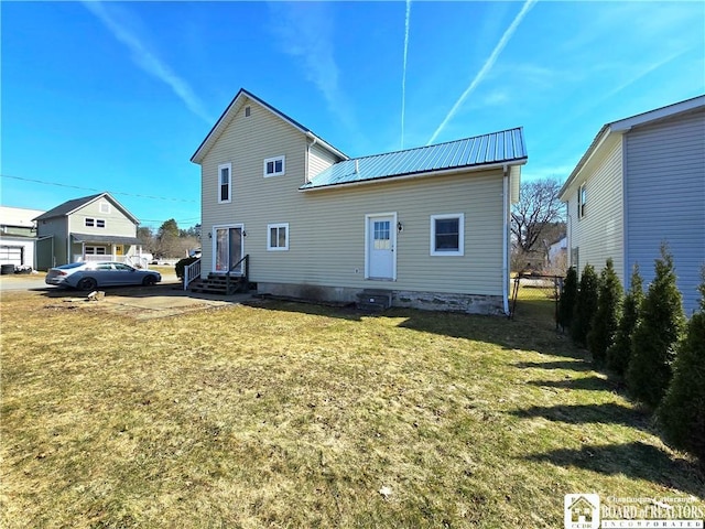216 S Pleasant St, Shinglehouse, PA 16748 - back of house featuring entry steps, metal roof, fence, and a lawn