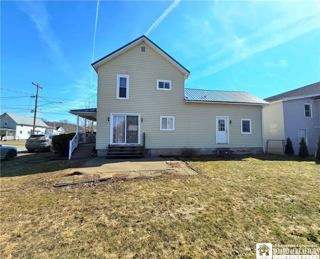 216 S Pleasant St, Shinglehouse, PA 16748 - back of property with entry steps, metal roof, and a lawn