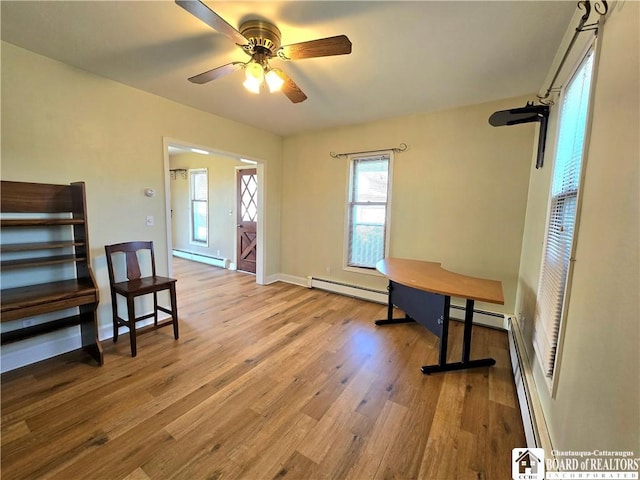 216 S Pleasant St, Shinglehouse, PA 16748 - interior space featuring baseboard heating, baseboards, a ceiling fan, and wood finished floors