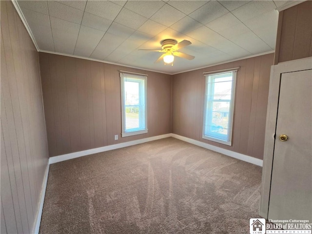 216 S Pleasant St, Shinglehouse, PA 16748 - carpeted spare room featuring crown molding, ceiling fan, baseboards, and wooden walls