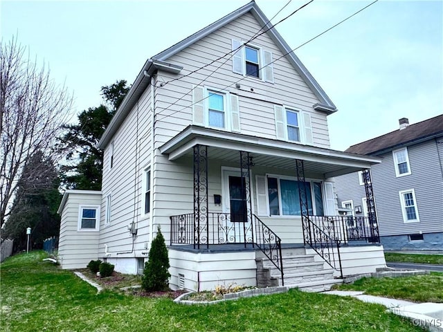 traditional style home featuring a front yard and covered porch