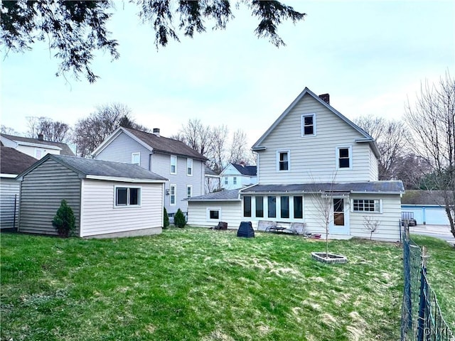 back of house with a yard and fence