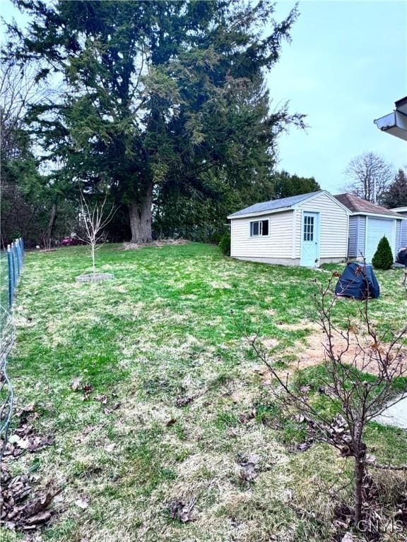 view of yard featuring fence and an outdoor structure