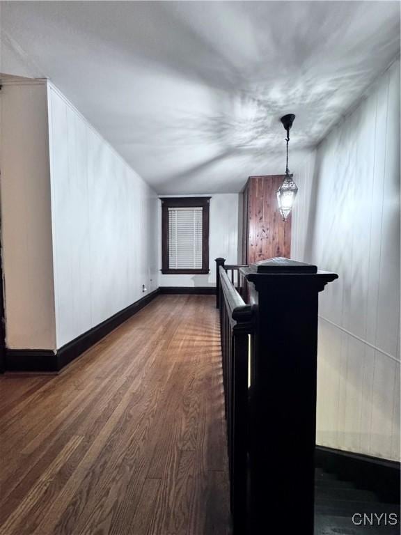 interior space with baseboards and dark wood finished floors