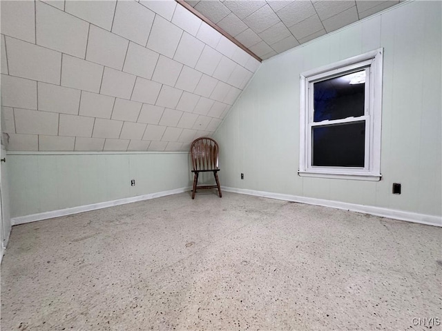 bonus room with baseboards and lofted ceiling