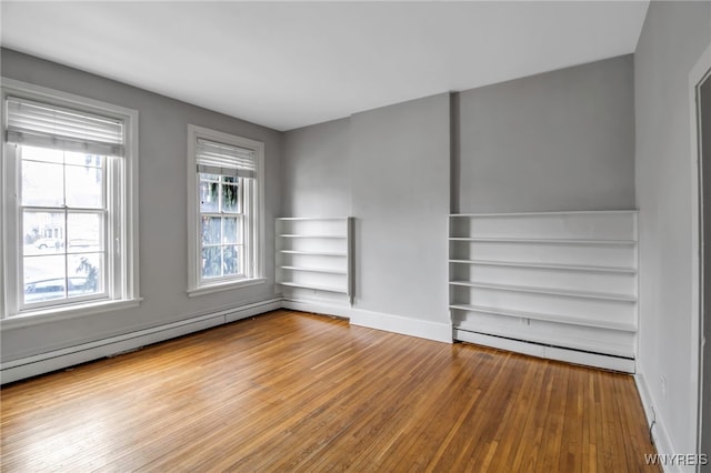 153 Allen St, Buffalo, NY 14201 - interior space featuring a baseboard heating unit, baseboards, and hardwood / wood-style flooring
