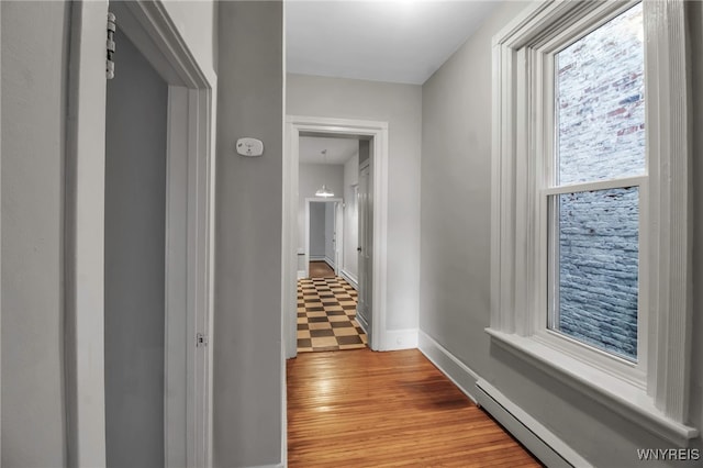 153 Allen St, Buffalo, NY 14201 - hallway featuring baseboards, a baseboard heating unit, and wood finished floors