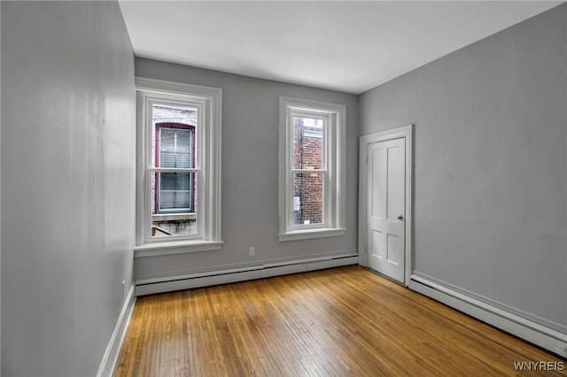 153 Allen St, Buffalo, NY 14201 - unfurnished room with baseboards, hardwood / wood-style floors, and baseboard heating