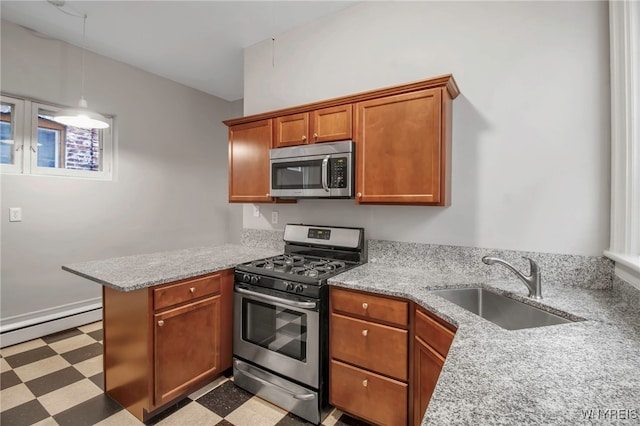 153 Allen St, Buffalo, NY 14201 - kitchen with a peninsula, a baseboard heating unit, a sink, stainless steel appliances, and tile patterned floors