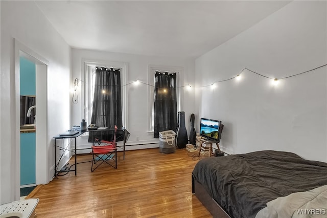 153 Allen St, Buffalo, NY 14201 - bedroom featuring light wood-style flooring and a baseboard heating unit