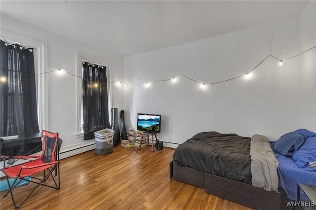 153 Allen St, Buffalo, NY 14201 - bedroom featuring a baseboard radiator and wood finished floors