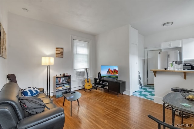 153 Allen St, Buffalo, NY 14201 - living room with cooling unit, light wood-style floors, and a baseboard heating unit