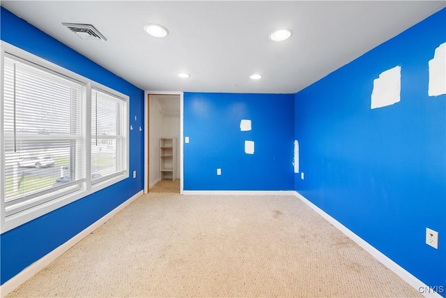 unfurnished bedroom with a closet, visible vents, recessed lighting, carpet flooring, and baseboards
