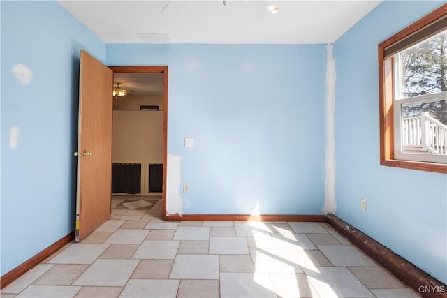 unfurnished room featuring baseboards