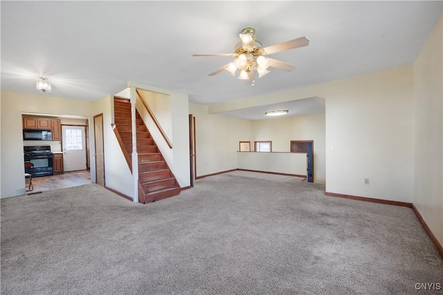 unfurnished living room featuring light carpet, baseboards, a ceiling fan, and stairs