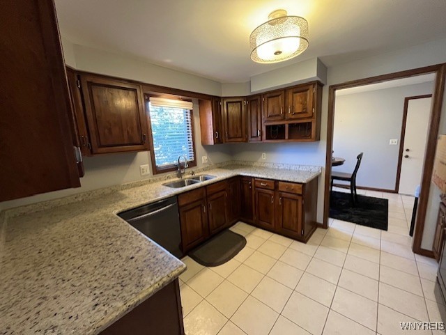 kitchen featuring a sink, open shelves, light stone counters, dishwasher, and light tile patterned floors