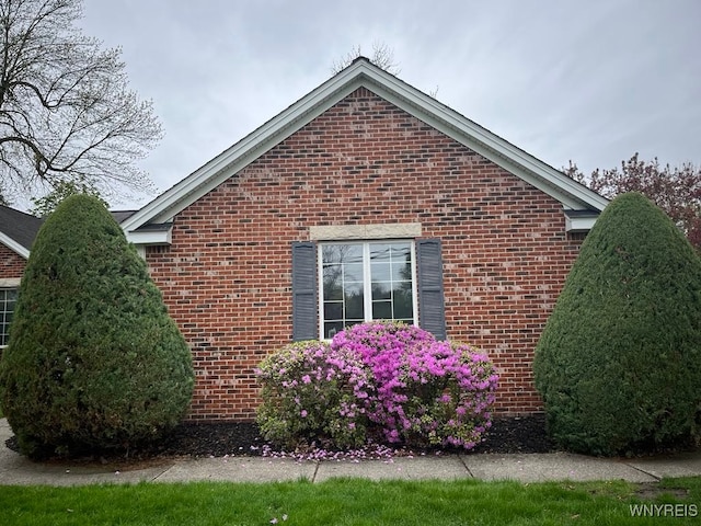 view of side of property with brick siding