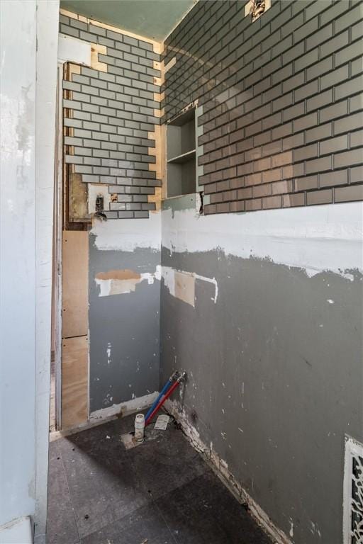 interior space featuring brick wall