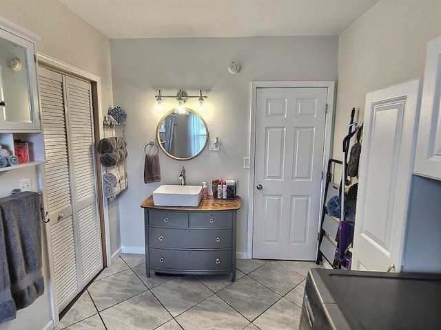 bathroom featuring a closet, tile patterned floors, vanity, and baseboards