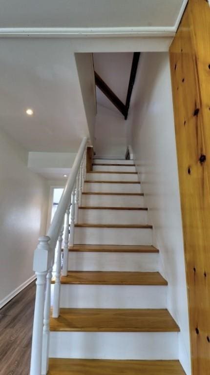 staircase featuring recessed lighting, baseboards, and wood finished floors