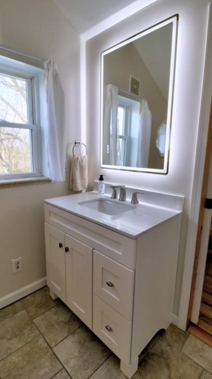 bathroom with vanity and baseboards