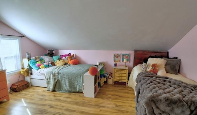 bedroom featuring light wood-style floors and lofted ceiling