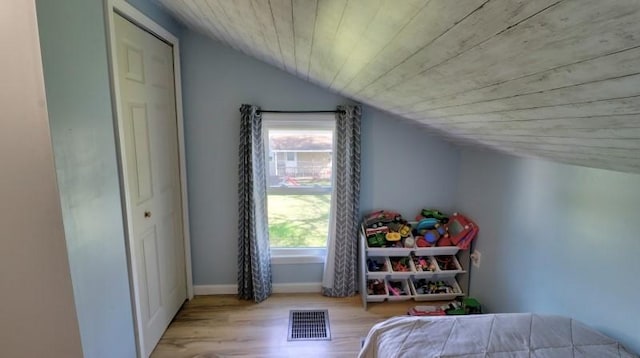 bedroom with visible vents, baseboards, wood ceiling, wood finished floors, and lofted ceiling