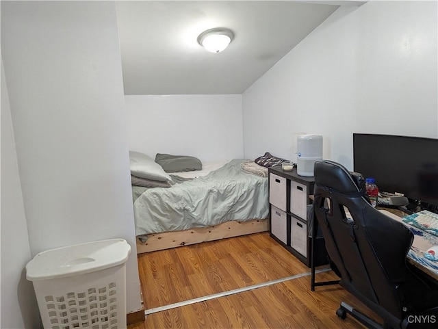 bedroom featuring vaulted ceiling and wood finished floors