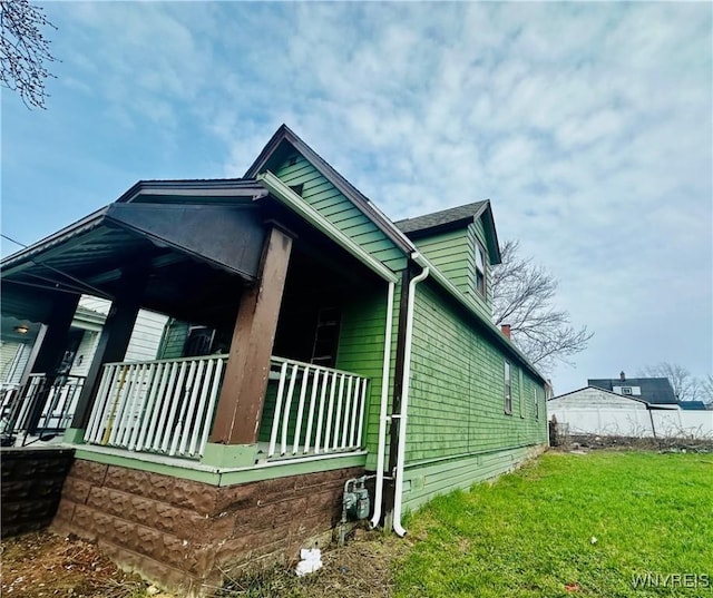 99 Roebling Ave, Buffalo, NY 14215 - view of side of property featuring covered porch and a lawn