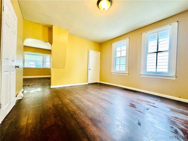 99 Roebling Ave, Buffalo, NY 14215 - spare room featuring visible vents, a wealth of natural light, wood finished floors, and baseboards