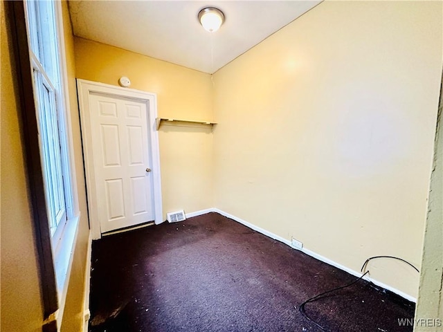 99 Roebling Ave, Buffalo, NY 14215 - unfurnished room featuring visible vents, baseboards, and dark carpet