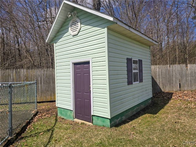 view of outbuilding featuring fence and an outdoor structure