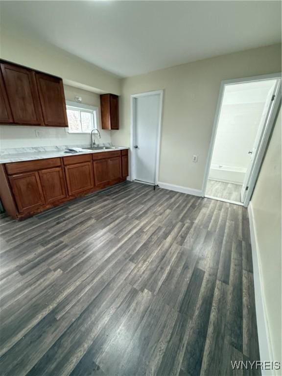 72 Person St, Buffalo, NY 14212 - kitchen featuring light countertops, a sink, dark wood-style floors, and baseboards