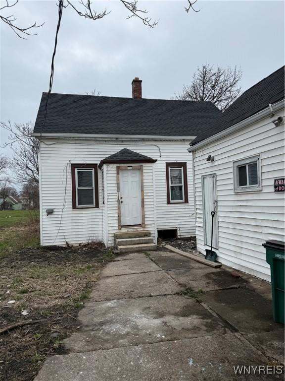 72 Person St, Buffalo, NY 14212 - view of front of home with entry steps, roof with shingles, and a chimney