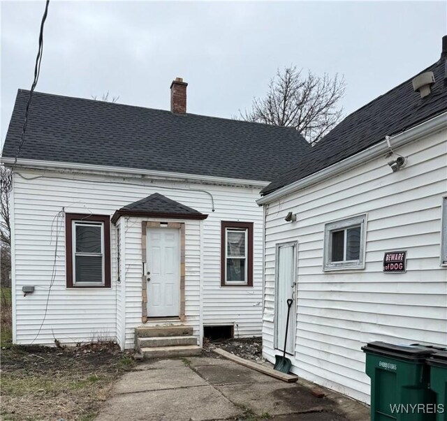72 Person St, Buffalo, NY 14212 - back of property featuring entry steps, a chimney, and a shingled roof