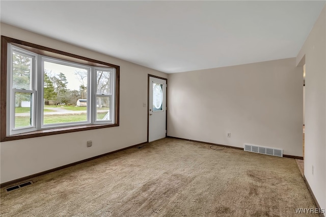 unfurnished room featuring visible vents, baseboards, and carpet floors