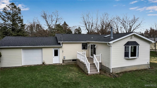 back of property featuring a yard, an attached garage, a deck, and a shingled roof