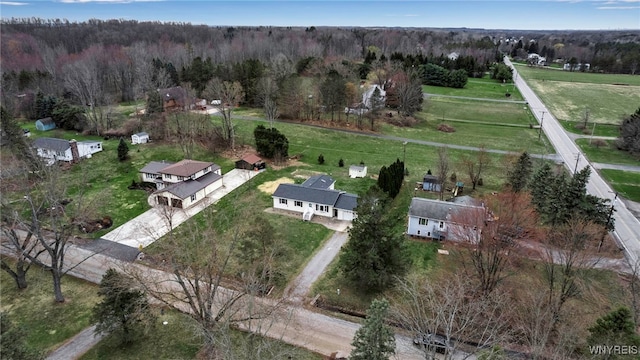 birds eye view of property featuring a forest view and a rural view