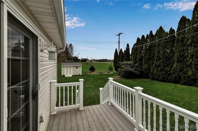 wooden terrace featuring a yard, an outbuilding, and a storage unit