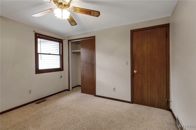 unfurnished bedroom with visible vents, baseboards, and light carpet