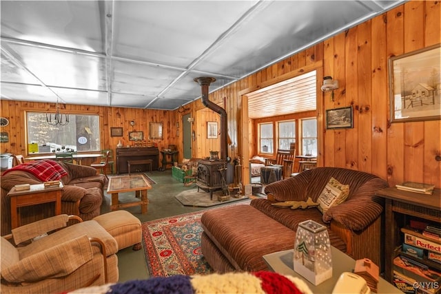 172 Green St, Ephratah, NY 13452 - living room featuring a wood stove, wooden walls, and concrete flooring