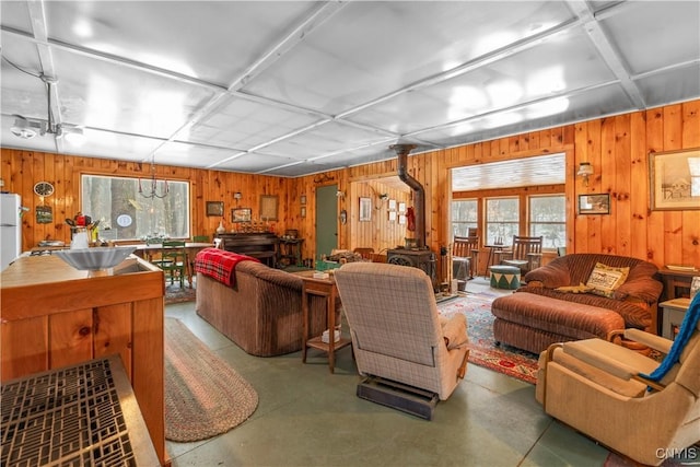 172 Green St, Ephratah, NY 13452 - living area featuring a wood stove and concrete flooring