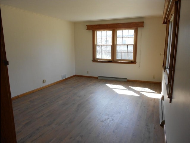 613 Hatfield St, Horseheads, NY 14845 - empty room featuring visible vents, baseboards, ornamental molding, wood finished floors, and a baseboard heating unit
