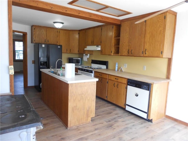 613 Hatfield St, Horseheads, NY 14845 - kitchen with light wood-type flooring, white appliances, light countertops, under cabinet range hood, and a sink